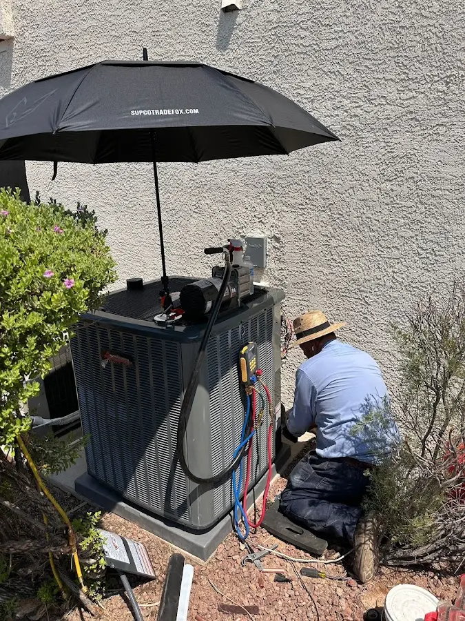 HVAC technician performing outdoor AC maintenance in Forest Grove